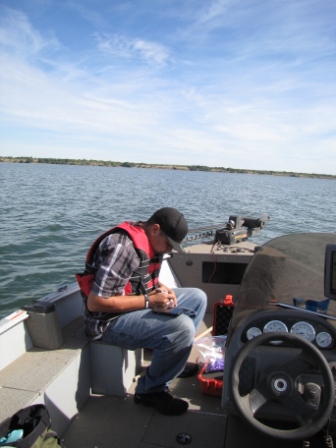 Steve Langdeau collecting water samples for E-coli